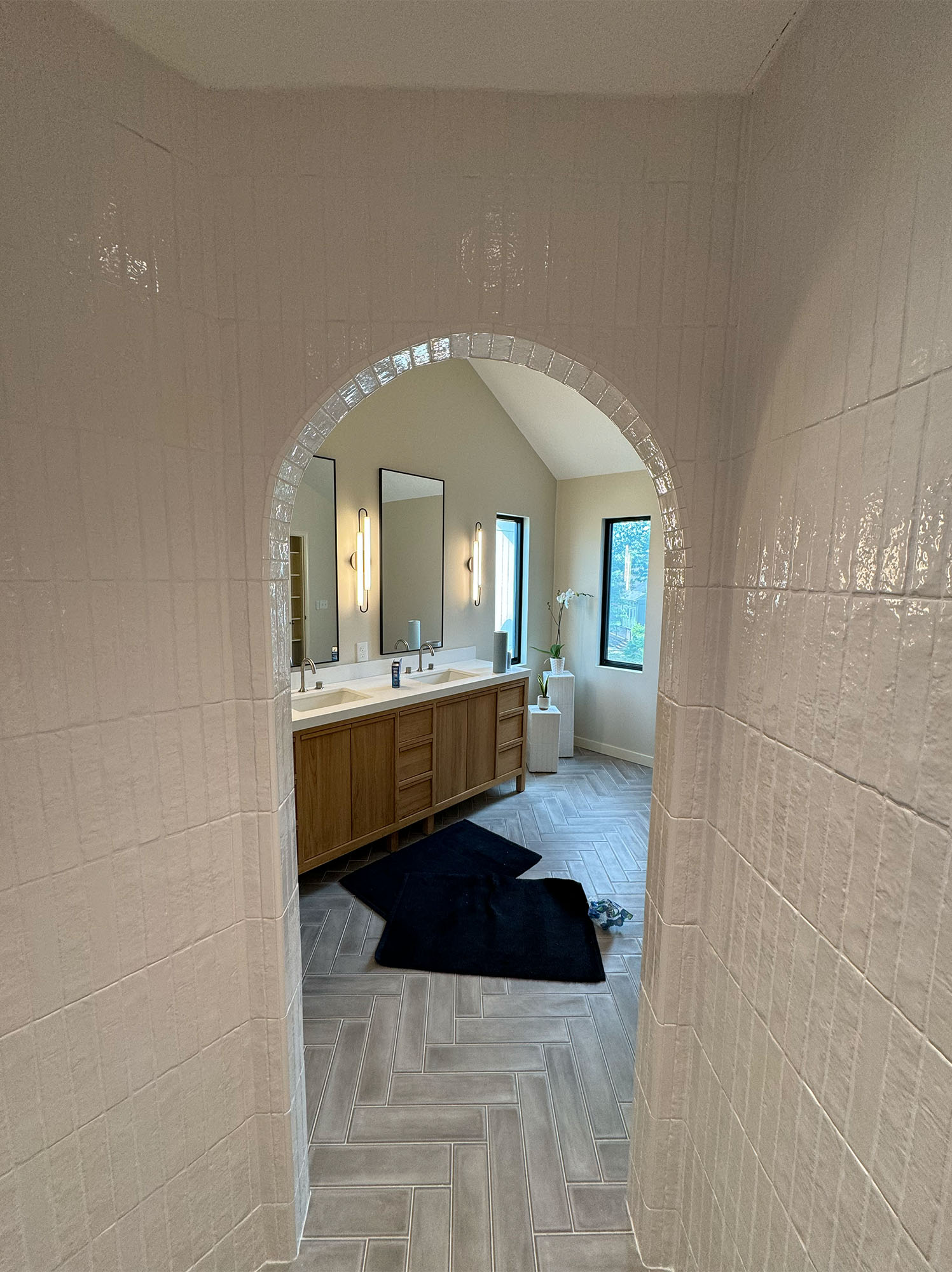 Inside tiled shower with archway